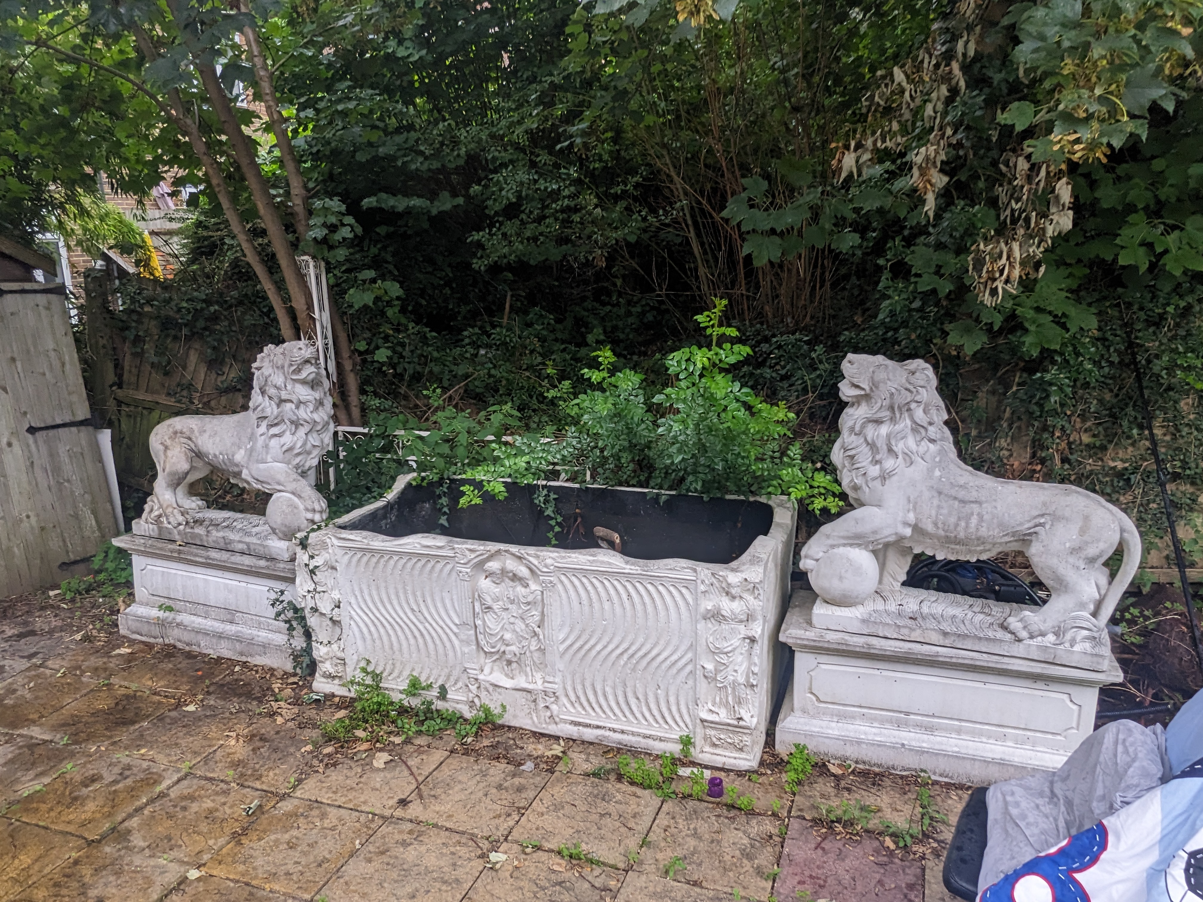 A pair of re-constituted stone models of lions standing upon rectangular plinths, fitted as fountains, Height 160cm., Viewing in Forest Row by arrangement. Purchaser to arrange for removal within one week of the sale dat